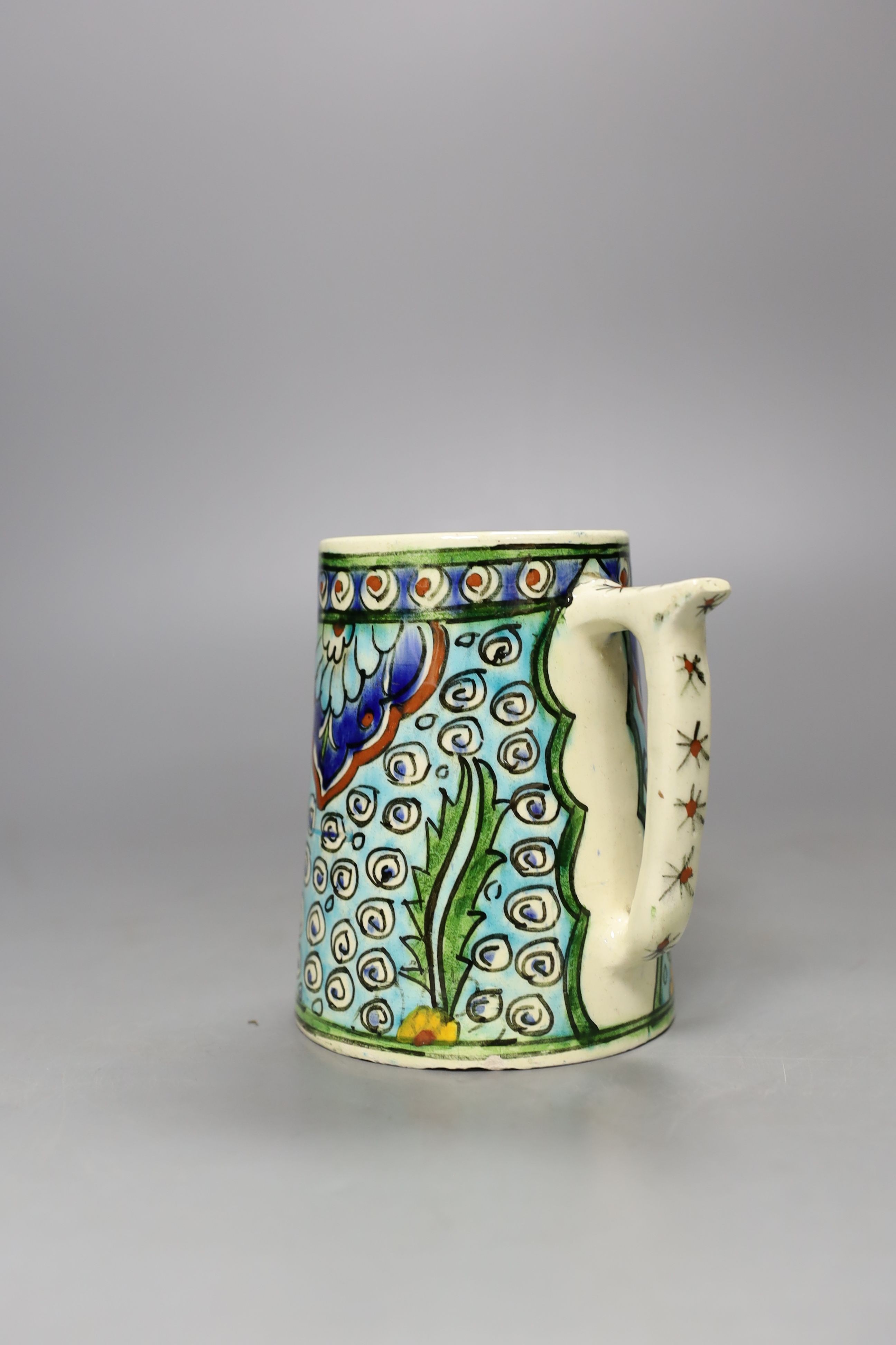 A Turkish Kutahya earthenware tapering mug, 12.5 cm high